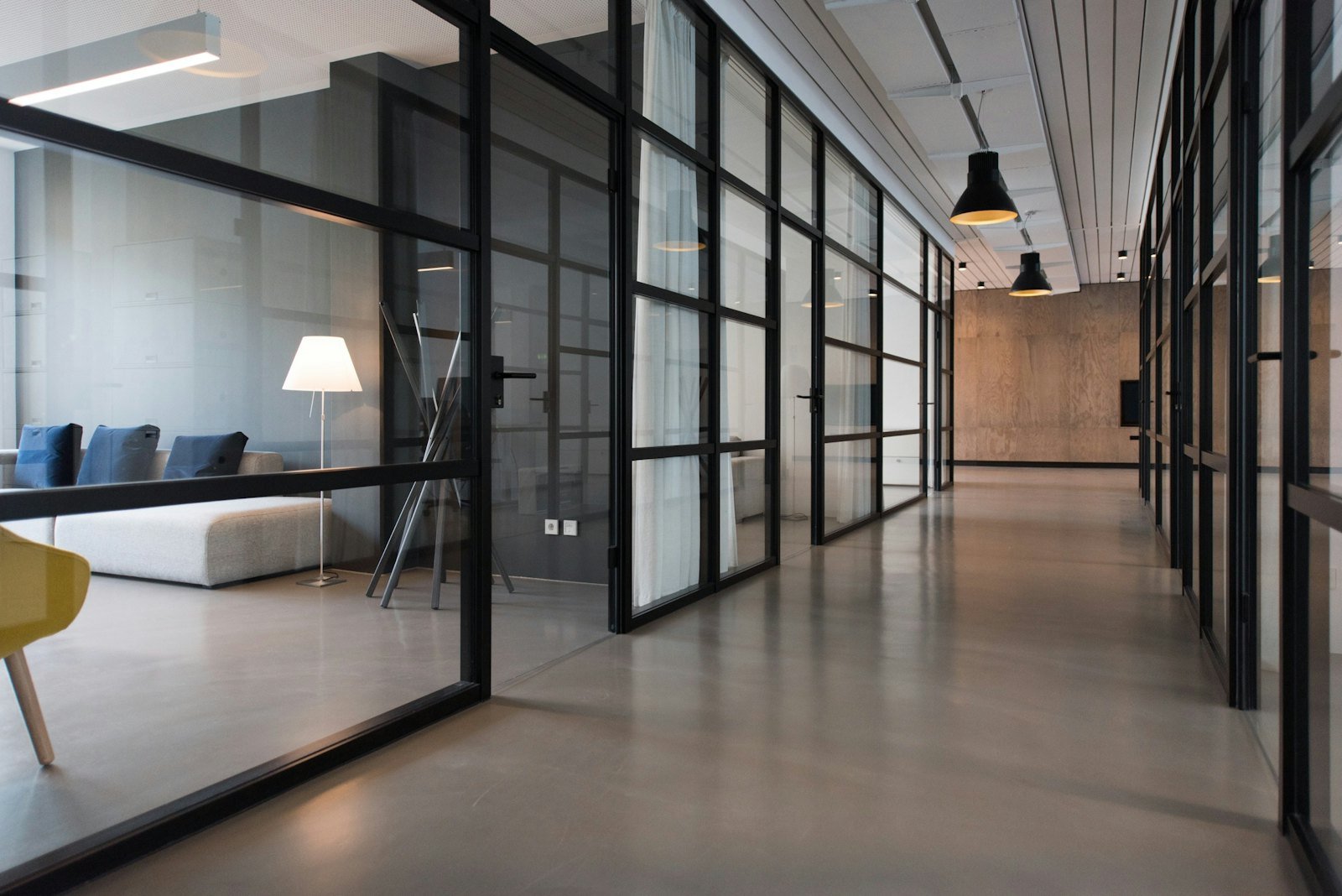 Bright corridor of a modern agency with glass partitions